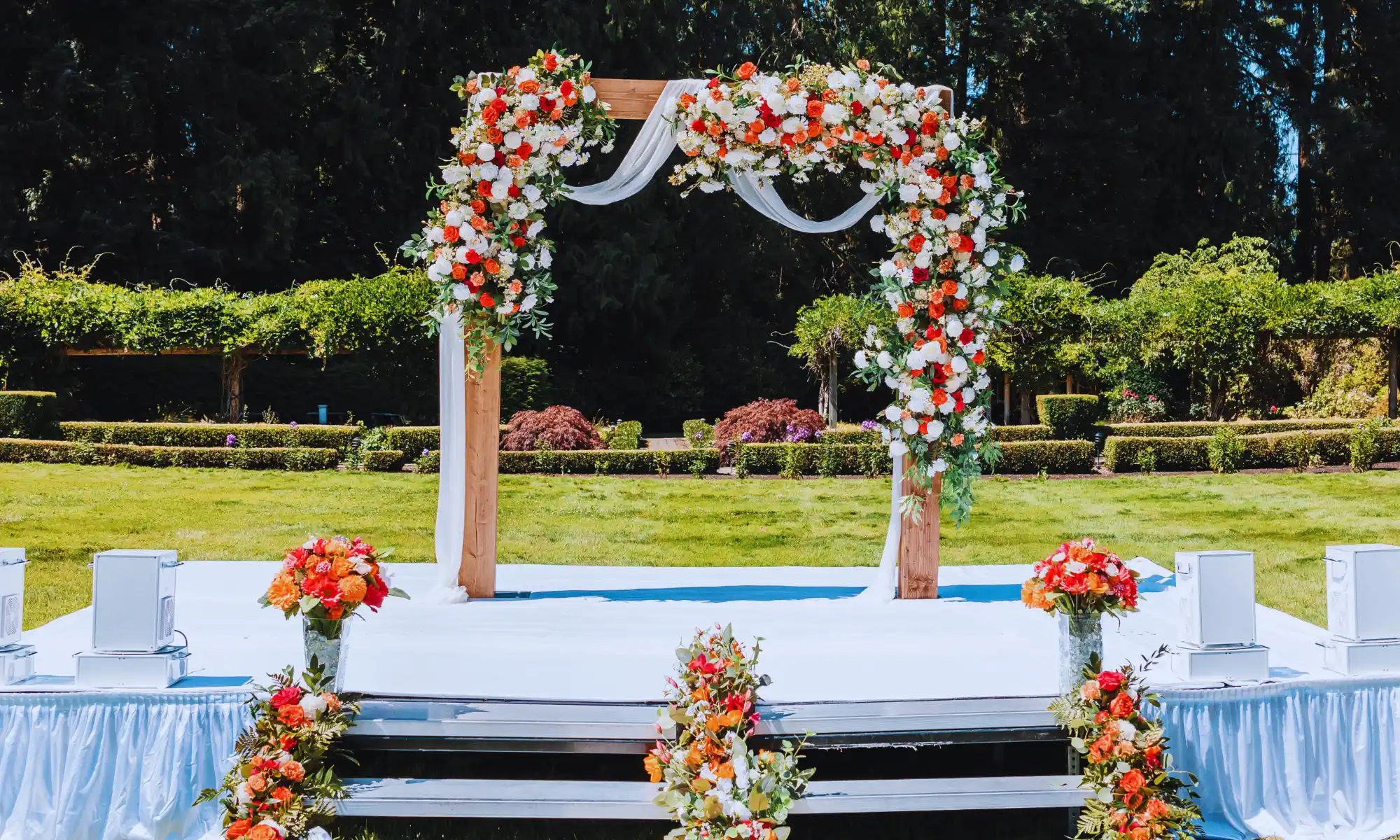 Outdoor wedding ceremony arch decorated with flowers at a destination wedding venue.