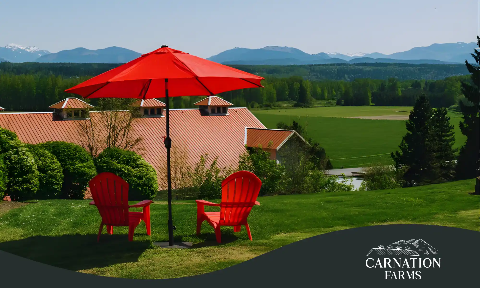 Red chairs overlooking the Snoqualmie Valley at Carnation Farms during a relaxing weekend stay.